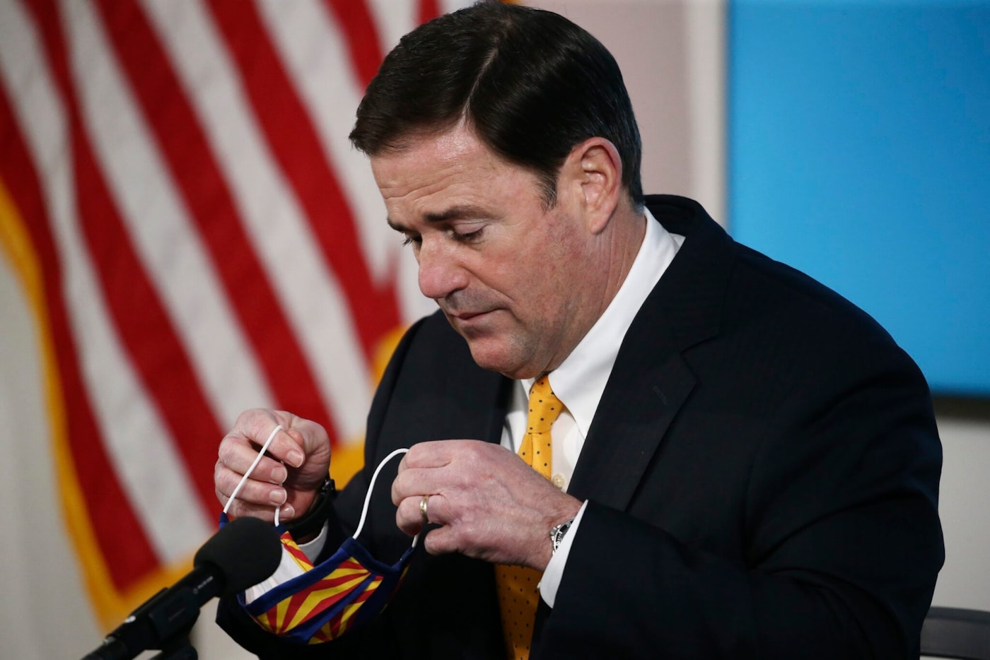 Arizona Republican Gov. Doug Ducey removes his face covering as he prepares to speak about the latest coronavirus data at a news conference Thursday, June 25, 2020, in Phoenix. (AP Photo/Ross D. Franklin, Pool)