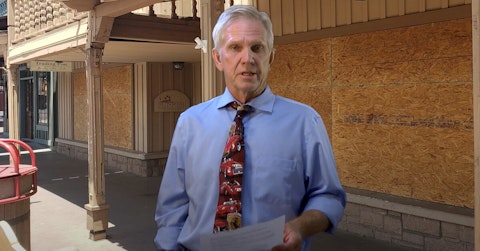 Guy Phillips standing in front of boarded-up businesses