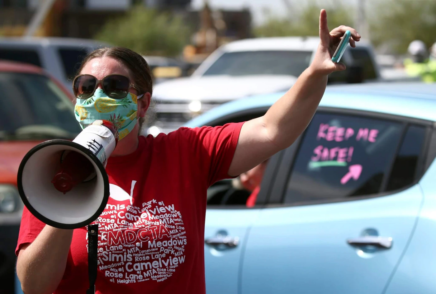 Local teacher Lisa Vaaler joins other teachers as they hold a #Return2SchoolSafely Motor March protest Wednesday, July 15, 2020, in Phoenix. Several Arizona teachers voiced fears about returning to school in a state that continues to be ravaged by the coronavirus. (AP Photo/Ross D. Franklin)