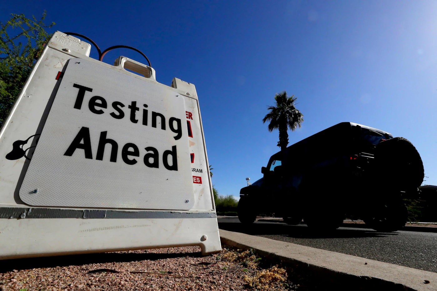 A vehicle arrives at COVID-19 testing site at Steele Indian School Park, Saturday, May 23, 2020, in Phoenix. The City of Phoenix and SonoraQuest are hosting a mobile COVID-19 testing blitz for area residents. (AP Photo/Matt York)