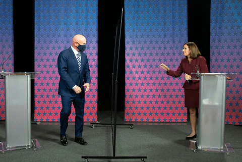 Mark Kelly and Martha McSally facing each other on debate stage