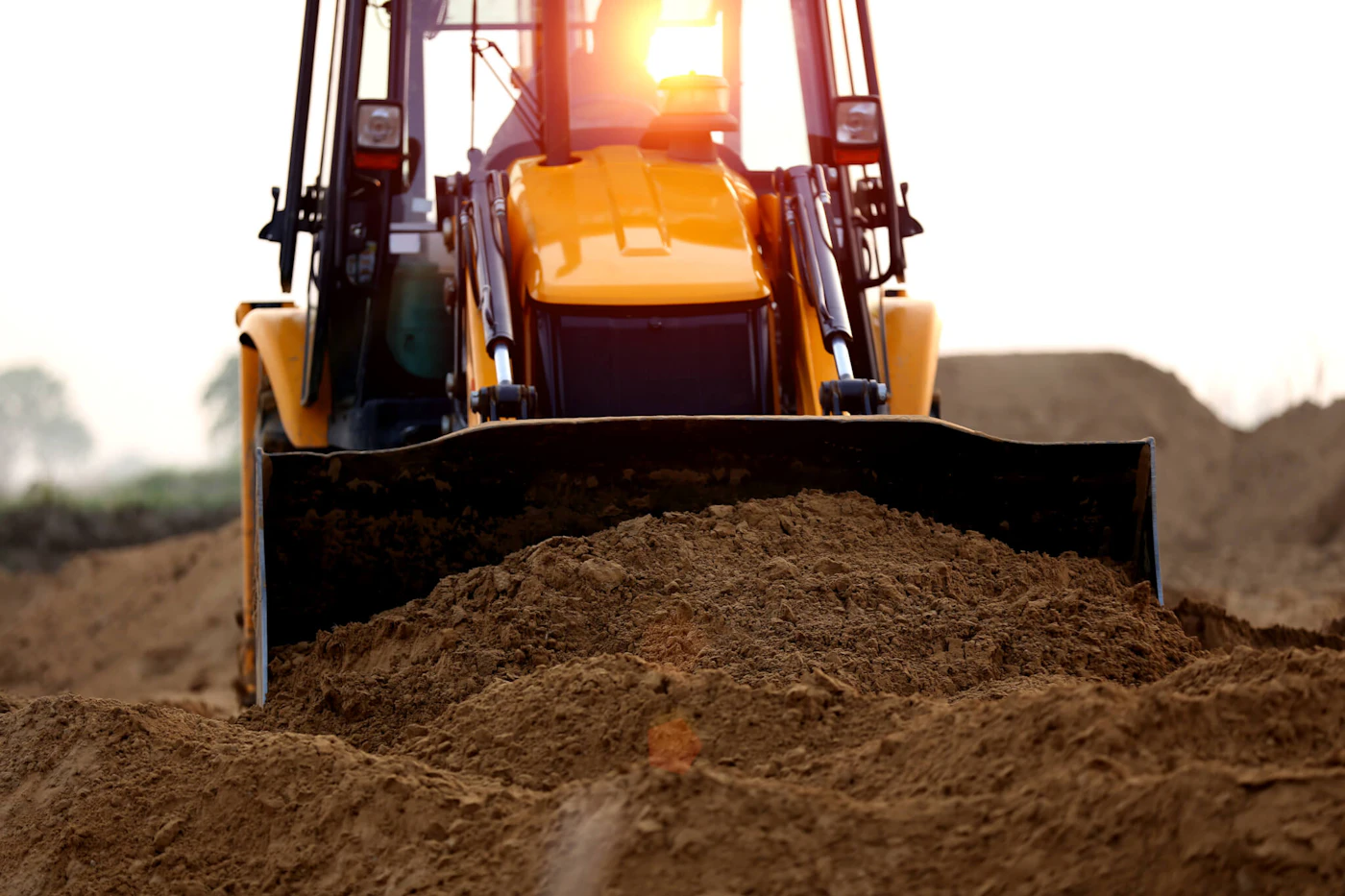 close-up of a heavy machine scooping dirt