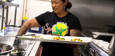 Maria Parra Cano of Sana Sana Foods prepares burritos with all-natural ingredients for food packages she sends to food-insecure people in south Phoenix. (Photo by Reyna Preciado/Special for Cronkite News)