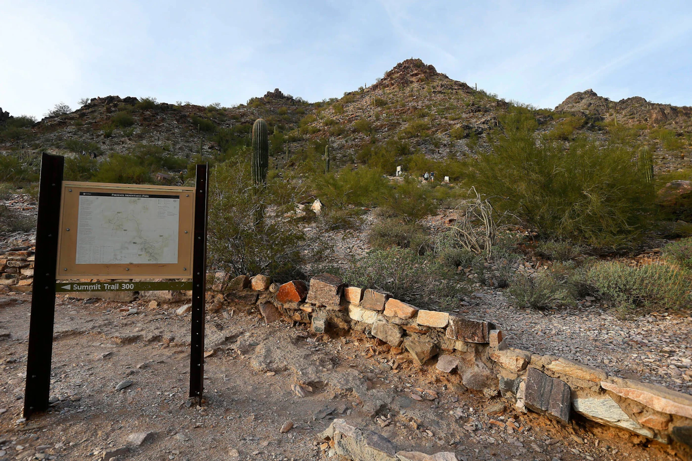 Hikers walk on the Phoenix Mountain Preserve trail up to Piestewa Peak in Phoenix on Tuesday, Jan. 10, 2017. A movement is afoot to change a controversial street name near the Phoenix mountain that formerly had a title which offended Native Americans and others. The mountain was changed from "Sq*** Peak" to "Piestewa Peak" more than a decade ago. Mayor Greg Stanton has called for a renaming of Sq*** Peak Drive and asked city staff last fall to start the name change process, The Arizona Republic reported. (AP Photo/Ross D. Franklin)