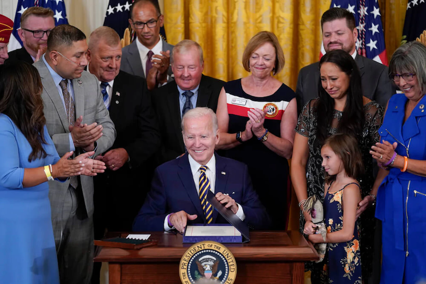 President Joe Biden signs the "PACT Act of 2022" during a ceremony in the East Room of the White House, Wednesday, Aug. 10, 2022, in Washington. (AP Photo/Evan Vucci)