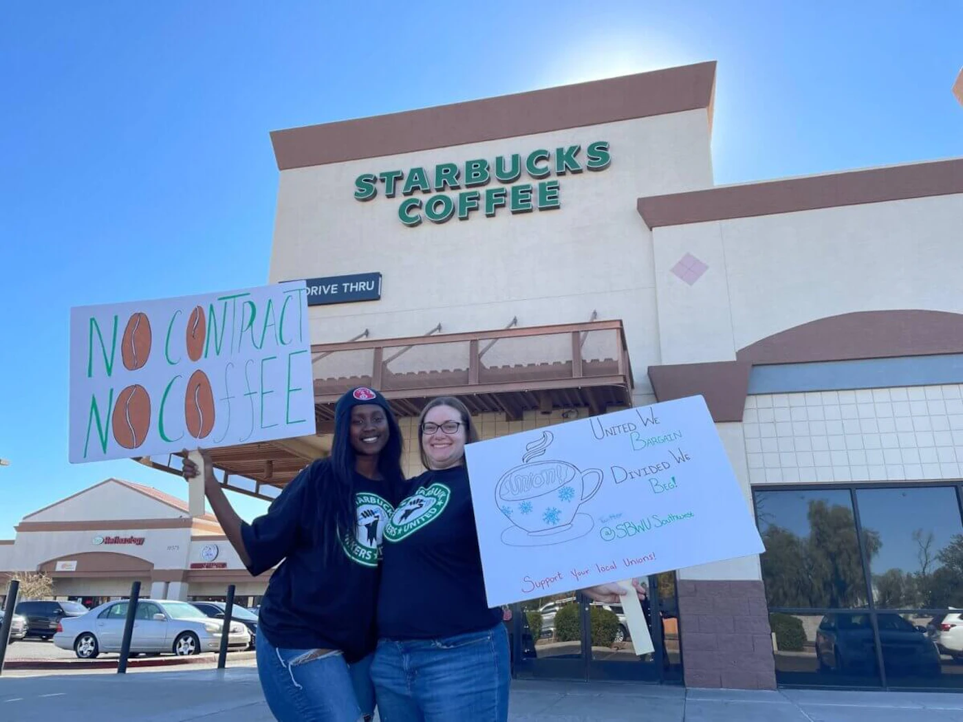 Baristas Natasha Mbazumutima and Cassidy Elliott pose in front of the Starbucks at 107th Avenue and Indian School Road in Avondale on Nov. 17, 2022. (Photo by Jessica Swarner)
