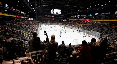 FILE - Fans watch as players warm up prior to the Arizona Coyotes' home-opening NHL hockey game against the Winnipeg Jets at the 5,000-seat Mullett Arena in Tempe, Ariz., Oct. 28, 2022. The Coyotes are about to learn the fate of a proposed entertainment district that will include a new arena. A referendum going before voters in the city of Tempe will determine whether plans for the $2.3 billion Tempe Entertainment District will move forward. (AP Photo/Ross D. Franklin, File)