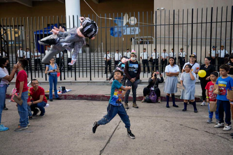 FILE - A child hits a piñata during a demonstration by supporters of Seed Movement presidential candidate Bernardo Arevalo, outside the Attorney General's Office headquarters, in Guatemala City, July 21, 2023. (AP Photo/Moises Castillo, File)