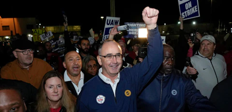 United Auto Workers President Shawn Fain walks with union members striking at Ford's Michigan Assembly Plant in Wayne, Mich., early Friday, Sept. 15, 2023. (AP Photo/Paul Sancya)