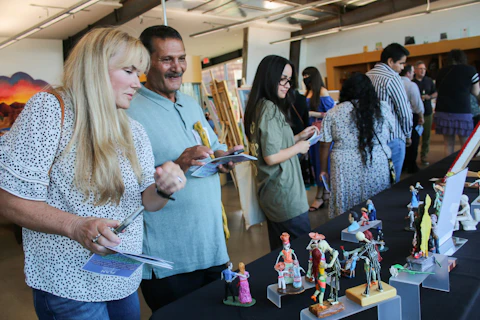 Joe, standing alongside a display of figurines he made. He learned to make them as a way to keep his mind and spirit free while incarcerated. Image courtesy Phoenix Legal Action Network