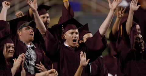 Arizona State University graduate students celebrate during their graduation ceremony. Photo by Joshua Lott/Getty Images