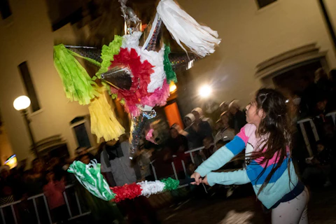 Los Angeles, CA - December 22:Children take turns smashing a piñata at Olvera Street in Los Angeles Thursday, December 22, 2022.  The piñata is part of the Las Posadas nightly procession from Dec. 16-23 which includes statues of Mary and Joseph being carried making stops at businesses along the street.  (Photo by David Crane/MediaNews Group/Los Angeles Daily News via Getty Images)