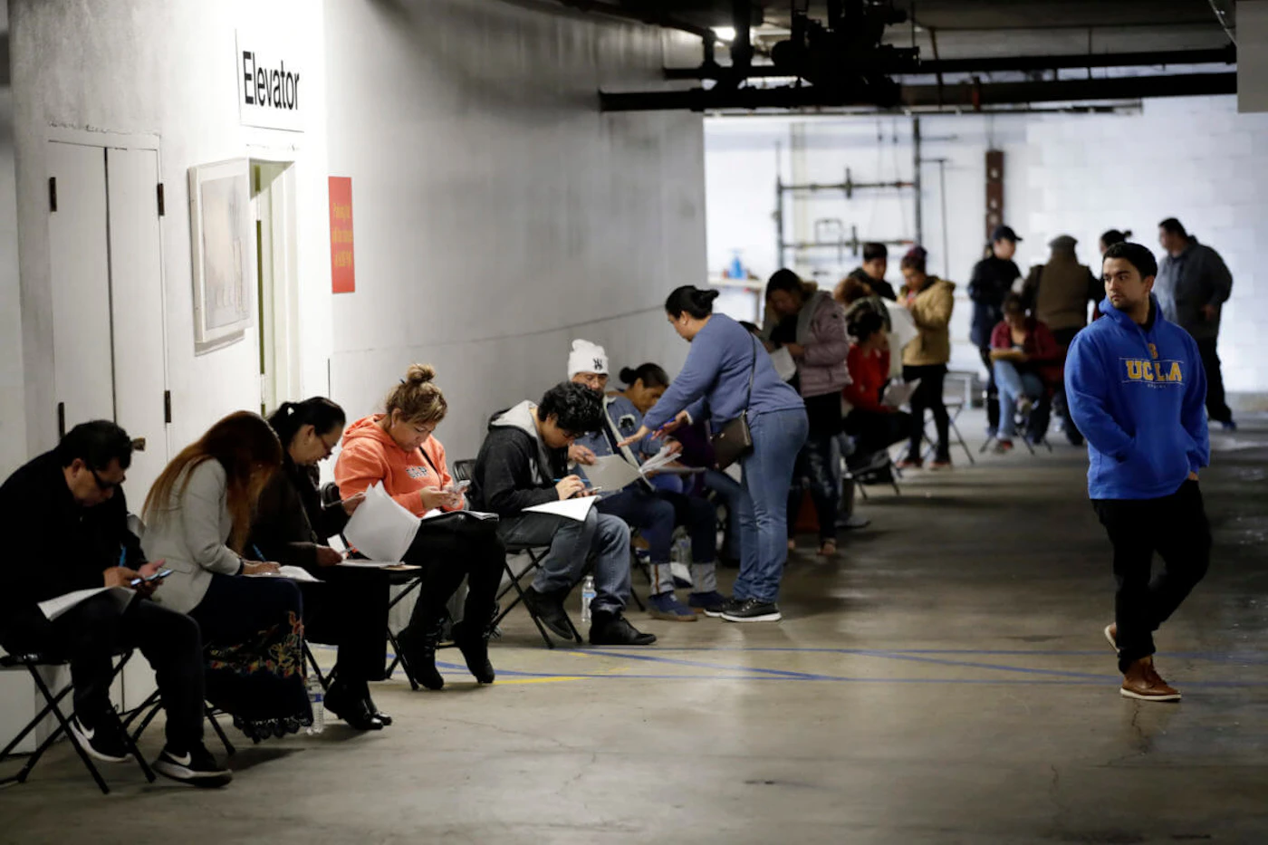 Long wait for help In this March 13, 2020 file photo, unionized hospitality workers wait in line in a basement garage to apply for unemployment benefits at the Hospitality Training Academy in Los Angeles. (AP Photo/Marcio Jose Sanchez, File)