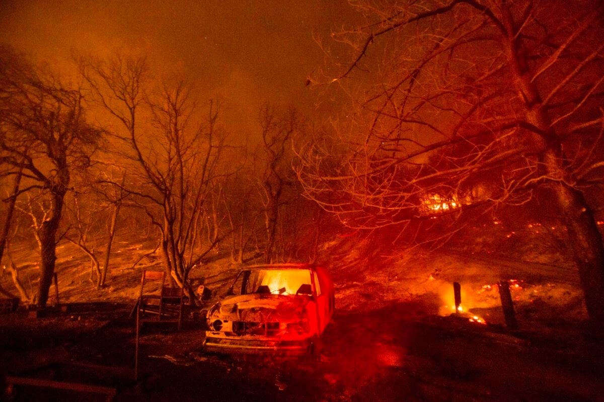 California Wildfires In this Aug. 13, 2020, file photo, a burned vehicle is seen in the Lake Hughes Fire in Angeles National Forest on Thursday, Aug. 13, 2020, north of Santa Clarita, Calif. (AP Photo/Ringo H.W. Chiu, File)