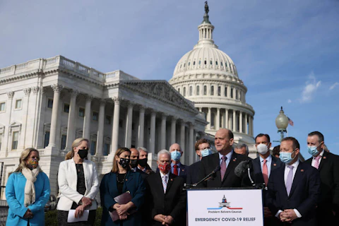 WASHINGTON, DC - DECEMBER 03:  Rep. Tom Reed (R-NY) (at lectern) and Rep. Josh Gottheimer (D-NJ) (2nd R), co-chairs of the bipartisan Problem Solvers Caucus, hold a news conference with fellow members of Congress to highlight the need for bipartisan, bicameral COVID-19 relief legislation outside the U.S. Capitol on December 03, 2020 in Washington, DC. With the holiday season approaching and the legislative session coming to a close, federal government funding for critical coronavirus relief programs is set to expire as the U.S. faces daily records for infections, hospitalizations, and deaths. (Photo by Chip Somodevilla/Getty Images)