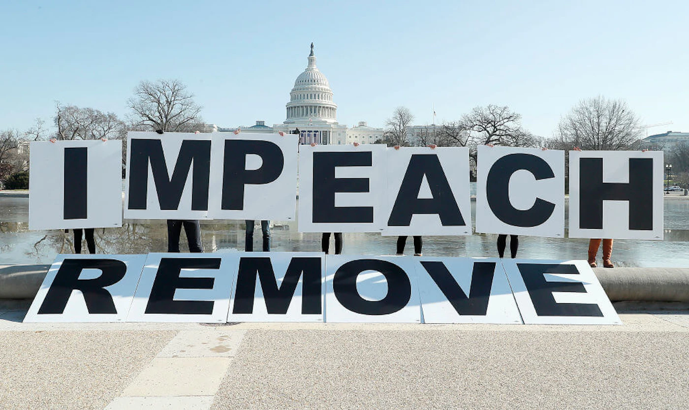 People gather at the base of the U.S. Capitol with large IMPEACH and REMOVE letters on January 12, 2021 in Washington, DC. The group is calling on Congress to impeach and remove President Donald Trump on the day that Democrats introduced articles of impeachment in response to Trump's incitement of a mob entering the U.S. Capitol Building on January 6. (Photo by Paul Morigi/Getty Images for MoveOn)