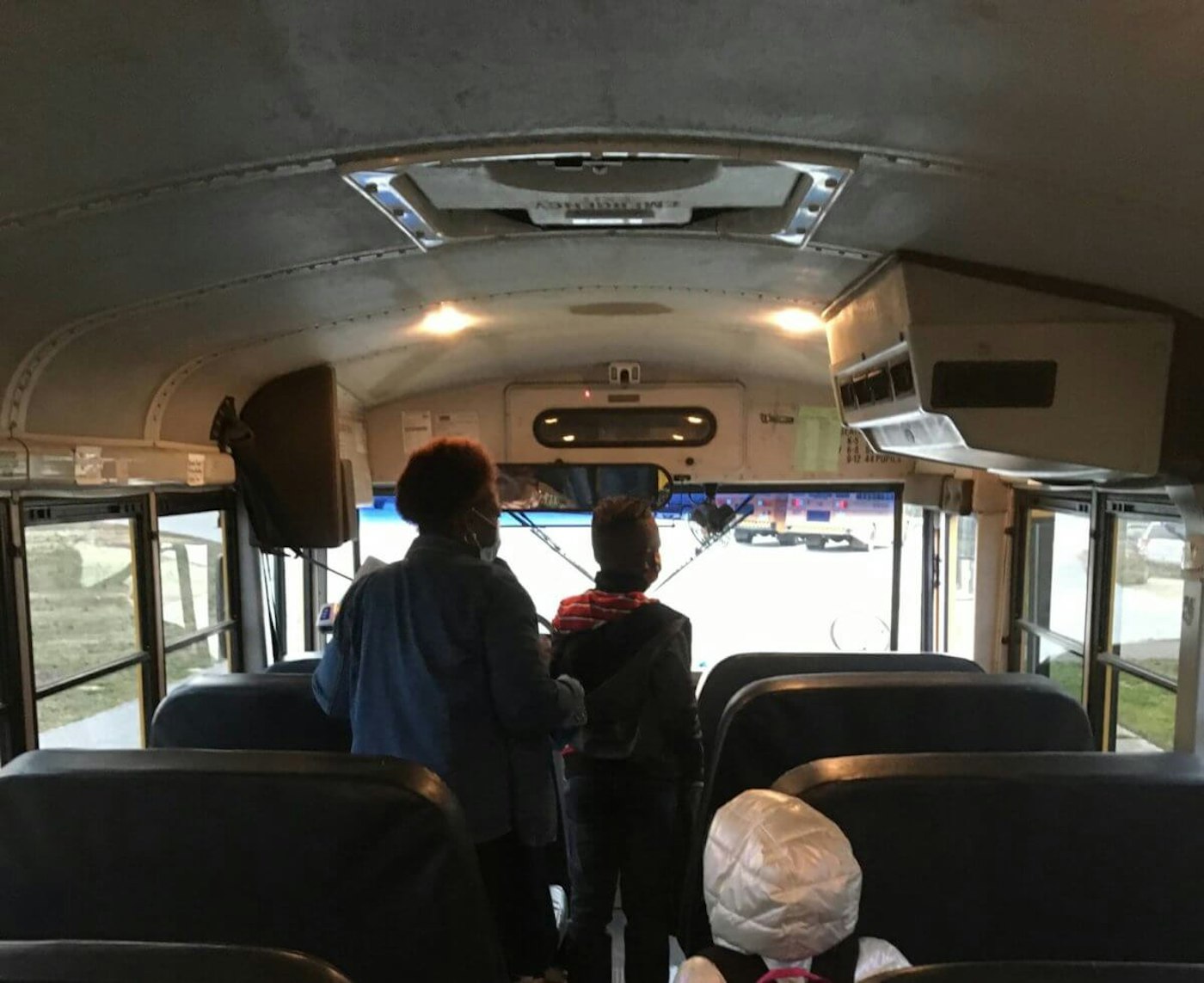 Students unload the bus on the first day of in-classroom learning in Halifax County, North Carolina on March 15, 2021. (Photo by Billy Ball)