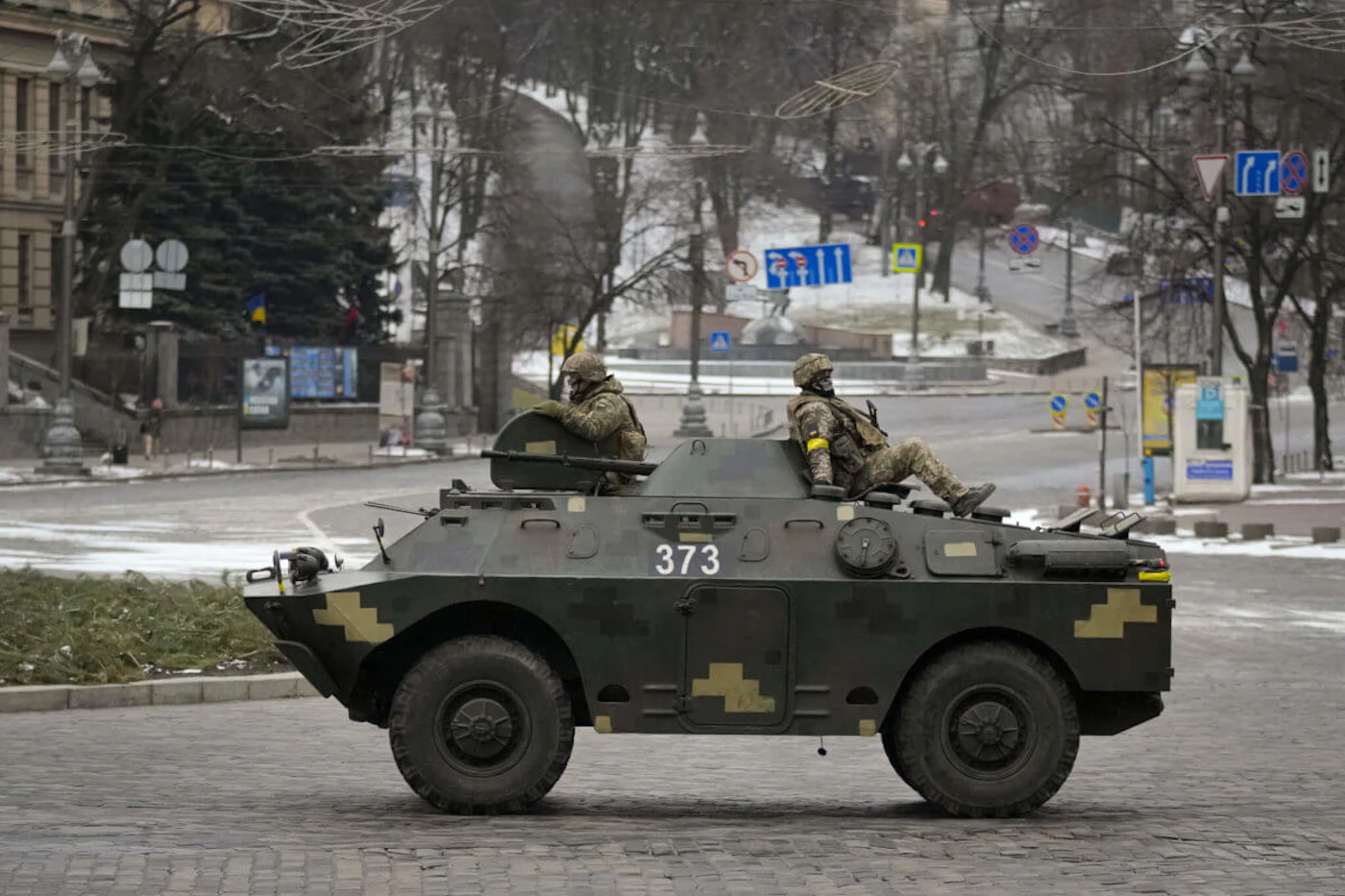 Ukrainian servicemen ride on top of an armored personnel carrier speeding down a deserted boulevard during an air raid alarm, in Kyiv, Ukraine, Tuesday, March 1, 2022. The U.N.'s refugees chief is warning that many more vulnerable people will begin fleeing their homes in Ukraine if Russia's military offensive continues and further urban areas are hit. (AP Photo/Vadim Ghirda)
