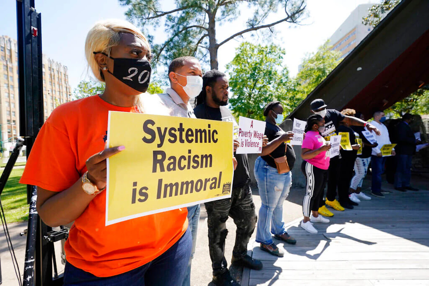 Participants of a Poor People's Campaign: A National Call for Moral Revival assembly and news briefing in Jackson, Miss., hold signs listing a variety of issues in April 2021. (Image via AP Photo/Rogelio V. Solis)