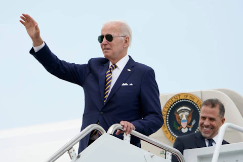 President Joe Biden waves as he boards Air Force One with his son Hunter Biden at Andrews Air Force Base, Md., Wednesday, Aug. 10, 2022. The president and his allies enjoyed one of their most positive weeks of his term so far, including the passage of a major climate change and healthcare bill called the Inflation Reduction Act. (AP Photo/Manuel Balce Ceneta)