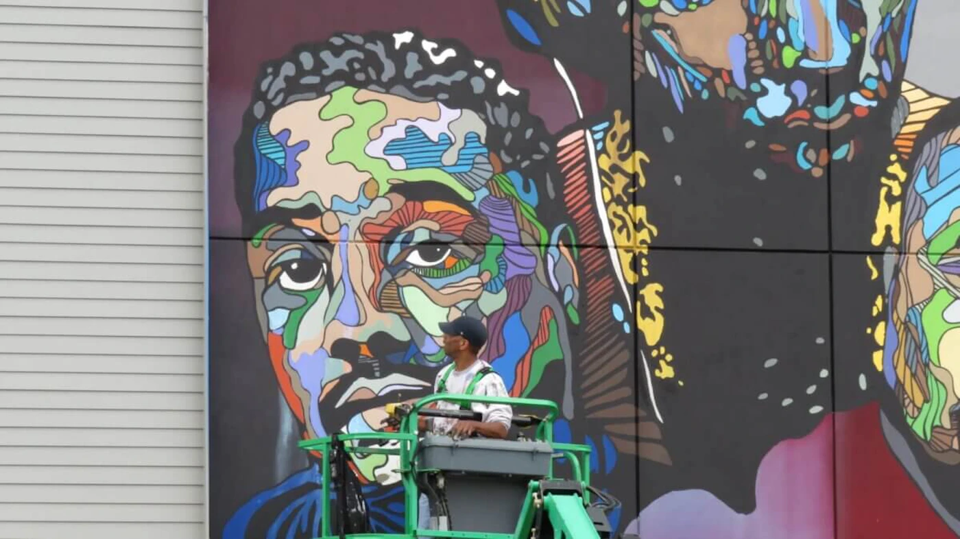 Durham artist Darius Quarles at work on a mural honoring local hip hop icons Little Brother. (Photo courtesy of Darius Quarles)