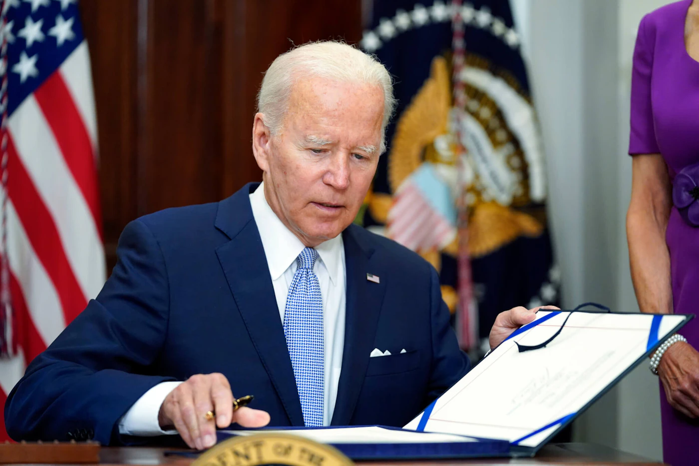 FILE - President Joe Biden signs into law S. 2938, the Bipartisan Safer Communities Act gun safety bill, in the Roosevelt Room of the White House in Washington, June 25, 2022. (AP Photo/Pablo Martinez Monsivais, File)