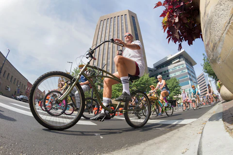 Bicyclists in the Tour De Fat bicycle parade in Idaho in 2016. New Belgium Brewing has moved operations into North Carolina. It's one of our picks for best trail-adjacent breweries to hit up in NC. (Shutterstock)
