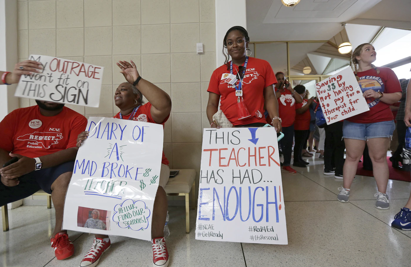 Teachers gather outside the Senate and House chambers during a teachers rally at the General Assembly in Raleigh, N.C., Wednesday, May 16, 2018. Thousands of teachers rallied the state capital seeking a political showdown over wages and funding for public school classrooms. (AP Photo/Gerry Broome)
