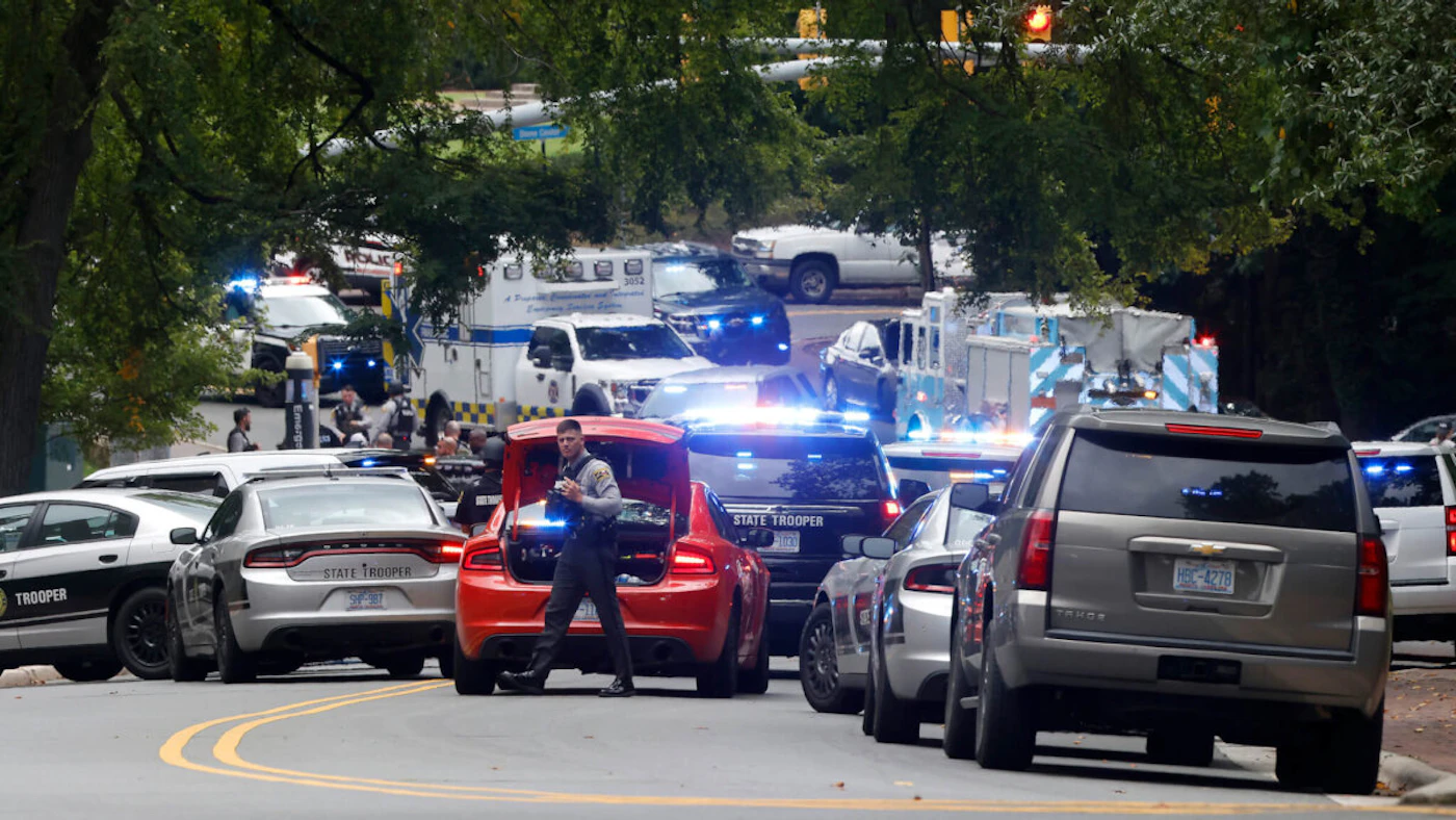 Law enforcement officers search for a person listed as 'armed and dangerous' on the campus of the University of North Carolina at Chapel Hill Monday afternoon, Aug. 28, 2023. (Kaitlin McKeown/News & Observer/Tribune News Service via Getty Images)