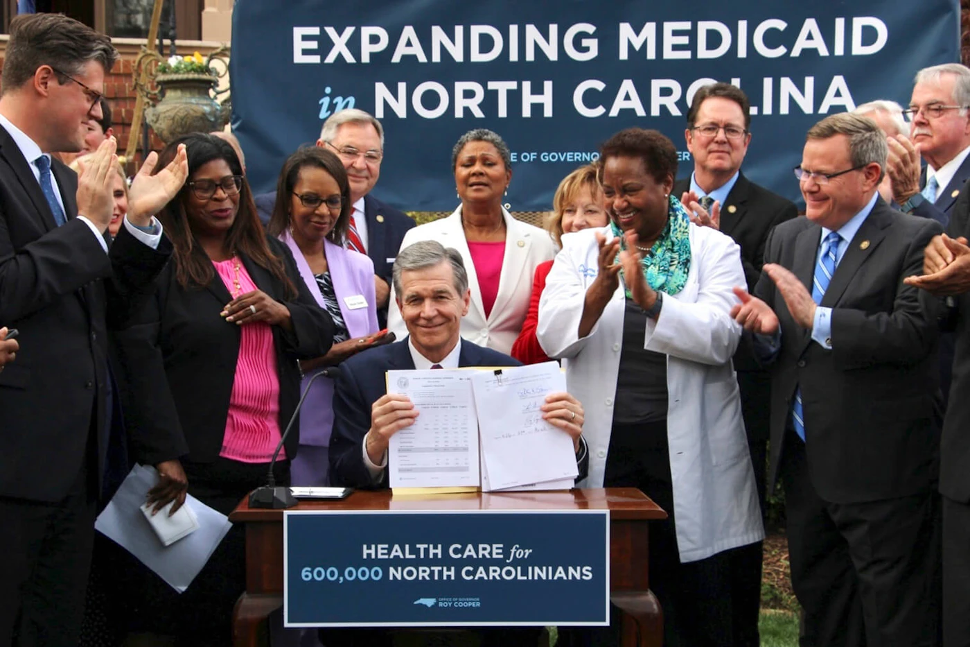 North Carolina Democratic Gov. Roy Cooper signs a Medicaid expansion law at the Executive Mansion on Monday, March 27, 2023, in Raleigh, N.C. (AP Photo/Hannah Schoenbaum)