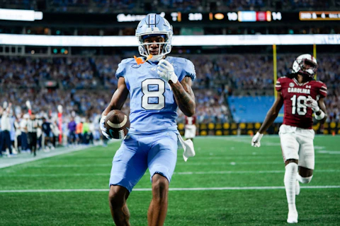 North Carolina wide receiver Kobe Paysour (8) runs in for a touchdown as South Carolina defensive back Keenan Nelson Jr. (18) looks on during the first half of an NCAA college football game Saturday, Sept. 2, 2023, in Charlotte, N.C. (AP Photo/Erik Verduzco)