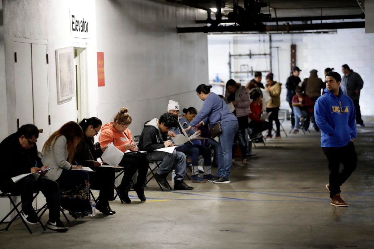 Unemployment claims increase In this March 13, 2020 file photo, unionized hospitality workers wait in line in a basement garage to apply for unemployment benefits at the Hospitality Training Academy in Los Angeles. (AP Photo/Marcio Jose Sanchez, File)