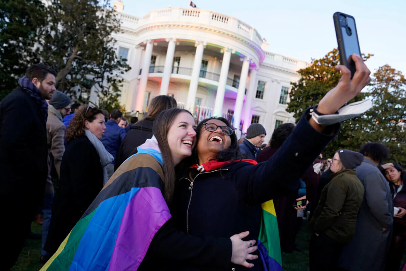 Aparna Shrivastava, right, takes a photo with her partner Shelby Teeter after President Joe Biden signed the Respect for Marriage Act, Tuesday, Dec. 13, 2022, on the South Lawn of the White House in Washington. (AP Photo/Andrew Harnik)