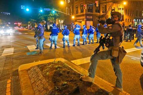 Police in Richmond, Va., respond to protests over the death of George Floyd, a black man who died after being restrained by Minneapolis police officers on May 25. (AP Photo/Steve Helber)