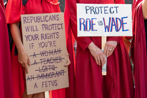 Women dressed as handmaids demonstrate against the infringement of reproductive rights as they join abortion-rights protesters at a rally in Los Angeles City Hall, Saturday, May 14, 2022. (AP Photo/Damian Dovarganes)