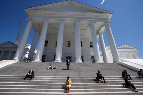 FILE - House of Delegates members eat boxed lunches on the steps of the Virginia Capitol in Richmond, Va., April 22, 2020. Even a short-term breach in the federal debt limit would rattle an already fragile state economy, Virginia finance staffers on Tuesday, May 16, 2023, told lawmakers, who say that looming uncertainty is now the main reason no budget deal is imminent. (Bob Brown/Richmond Times-Dispatch via AP, Pool, File)