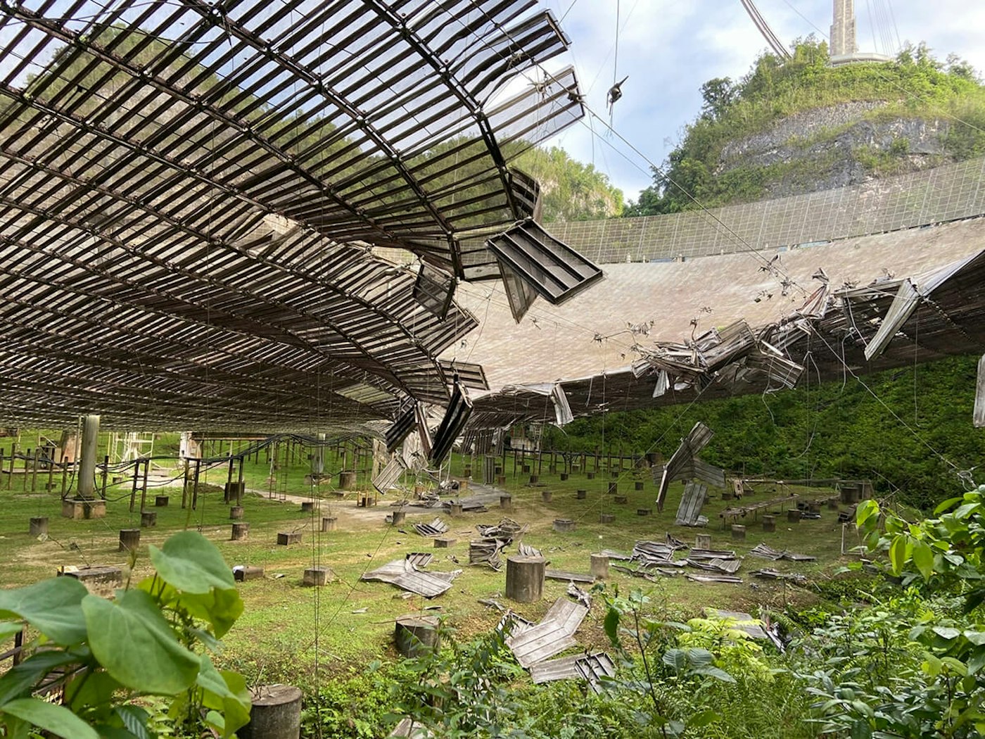 This file photo shows the damage done by a broken cable that supported a metal platform, creating a 100-foot gash to the radio telescope's reflector dish in Arecibo, Puerto Rico. Puerto Rico - Troubled Telescope