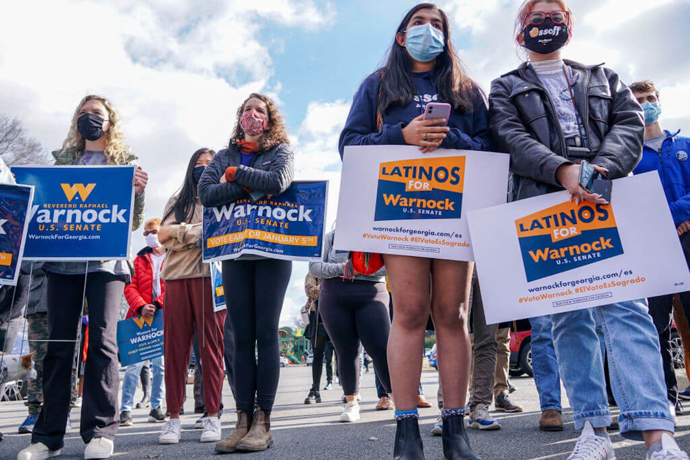 Volunteers listen to then-candidate Raphael Warnock speak during a canvassing event on January 5, 2021 in Marietta, Georgia. Photo by Sandy Huffaker/AFP via Getty Images.
