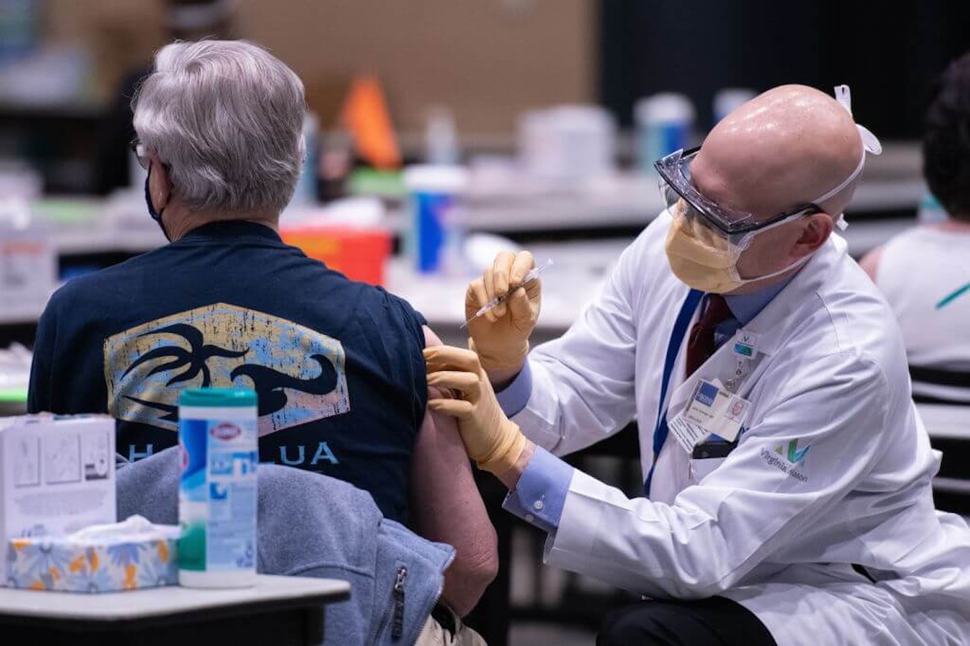 Chief clinical officer John Corman MD at Virginia Mason administers a dose of the Pfizer Covid-19 vaccine at the Amazon Meeting Center in downtown Seattle, Washington on January 24, 2021. - (Photo by GRANT HINDSLEY/AFP via Getty Images)