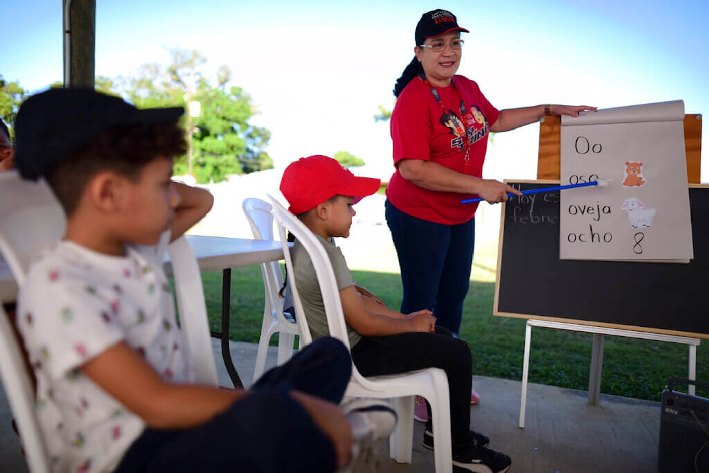 In this file photo, Martin G. Brumbaugh School kindergarten teacher Nydsy Santiago gives class to her students under a gazebo at a municipal athletic park in Santa Isabel, Puerto Rico, in February 2020. Puerto-Rico-Out-of-School