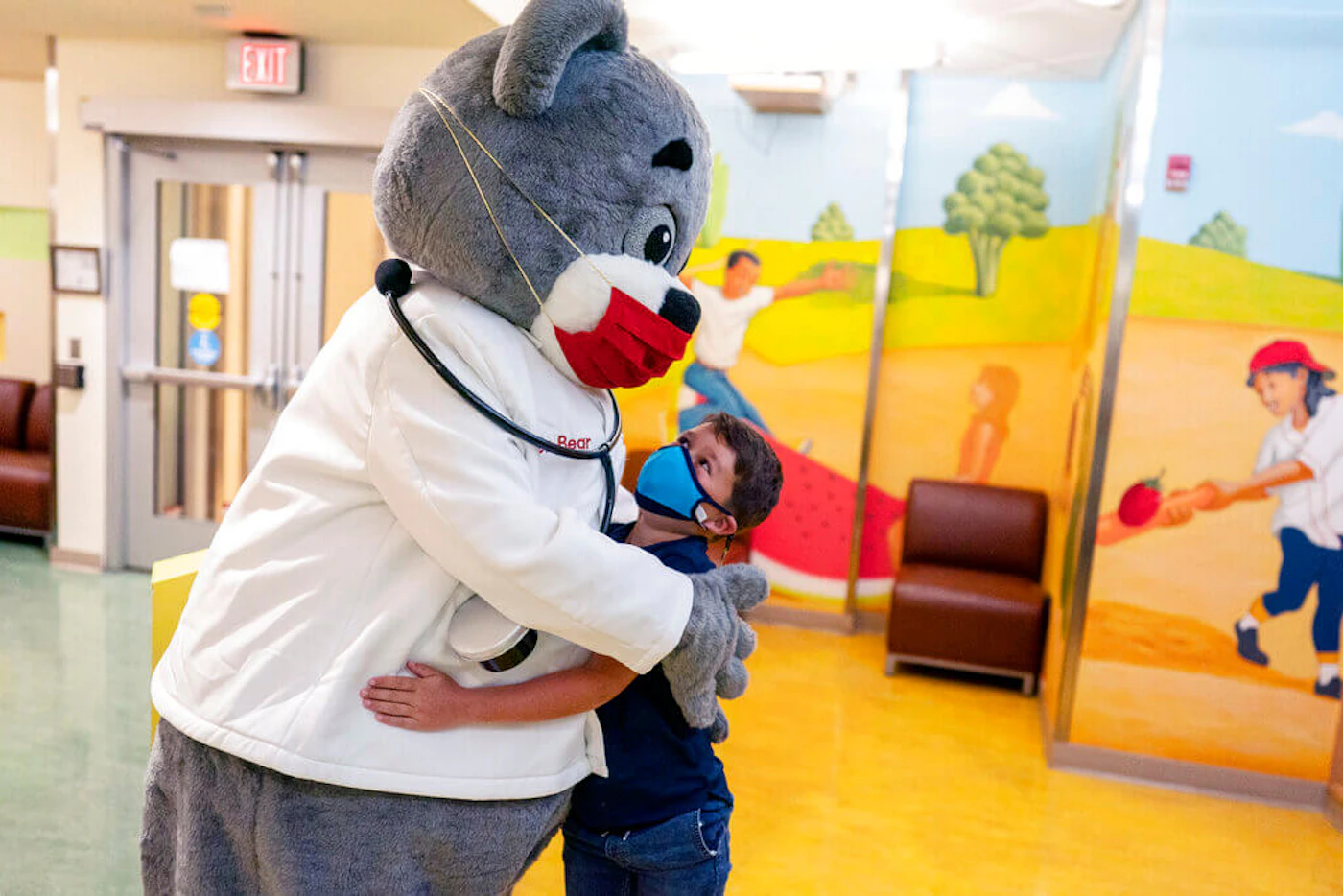 Carter Giglio, 8, hugs Dr. Bear before being vaccinated, Wednesday, Nov. 3, 2021, at Children's National Hospital in Washington. children-covid-vaccine