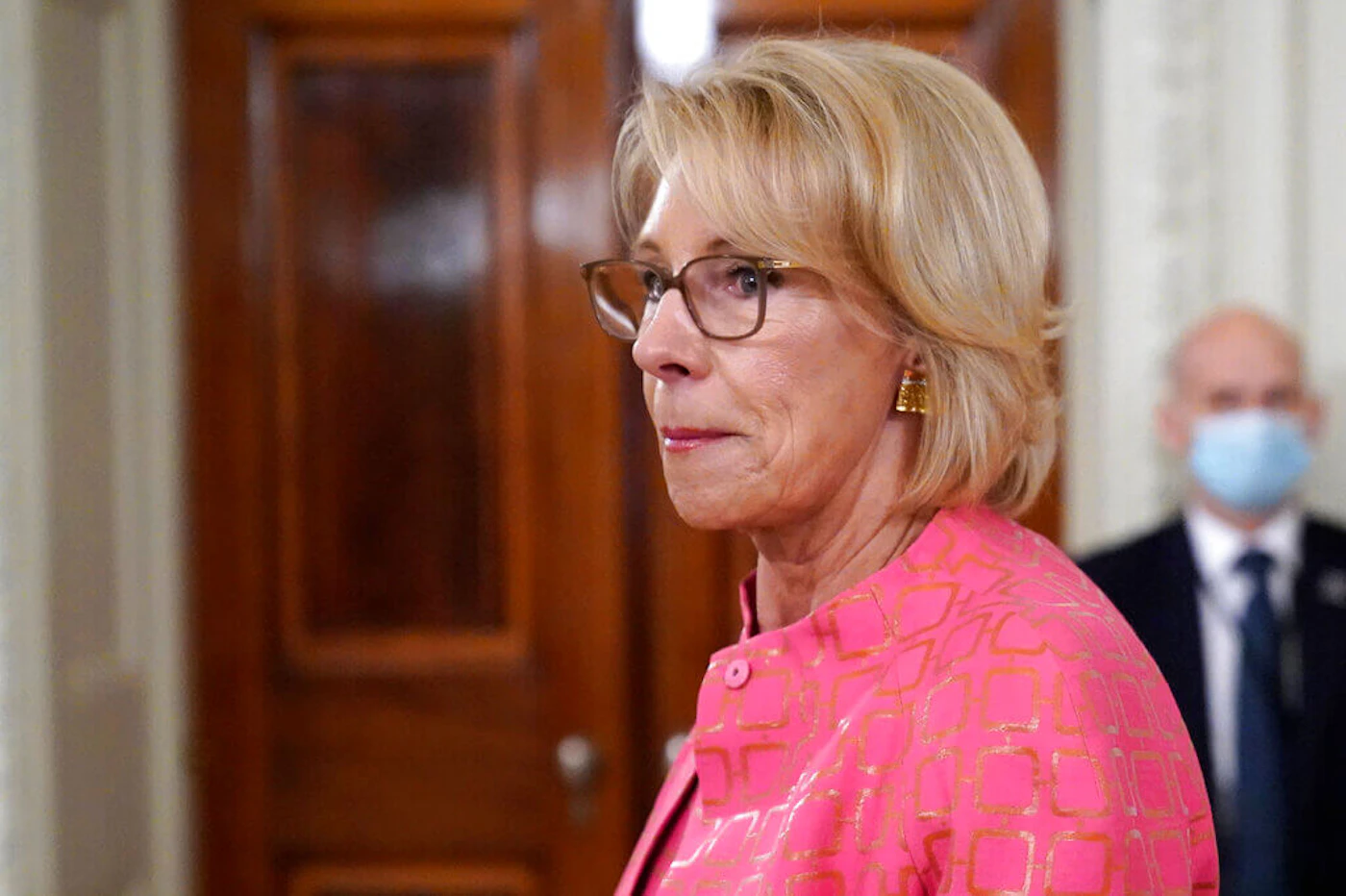 Education Secretary Betsy DeVos arrives for an event in the State Dining room of the White House, Wednesday, Aug. 12, 2020, in Washington. A federal judge on Wednesday allowed the Education Department to move forward with new rules governing how schools and universities respond to complaints of sexual assault. (AP Photo/Andrew Harnik, File)