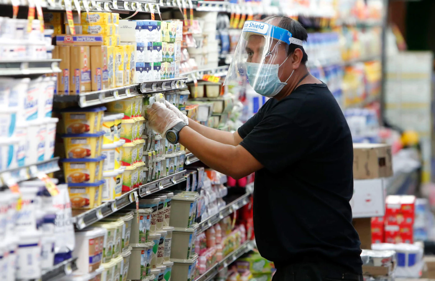 Amid concerns of the spread of COVID-19, a worker restocks products at a grocery store in Dallas, Wednesday, April 29, 2020.