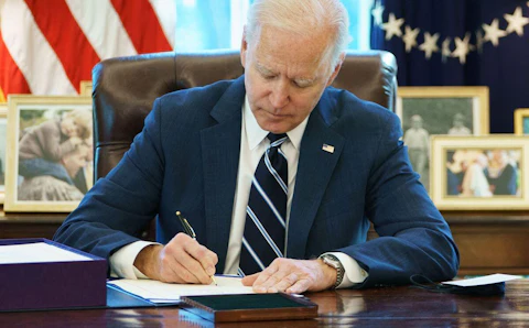 President Joe Biden signs the American Rescue Plan on March 11, 2021, in the Oval Office of the White House in Washington, DC. (Photo by MANDEL NGAN/AFP via Getty Images)
