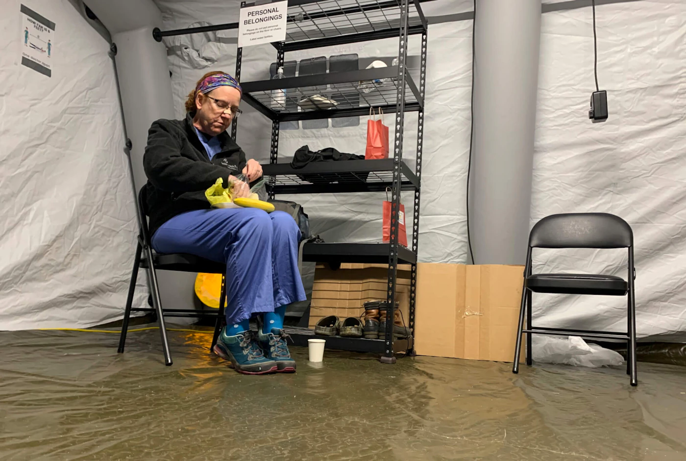 Chris Rutledge, a nurse for Samaritan’s Purse, eats lunch in January 2021 during the only short break of her 12-hour shift inside the COVID-19 field hospital in Lenoir, N.C. (AP Photo/Sarah Blake Morgan)