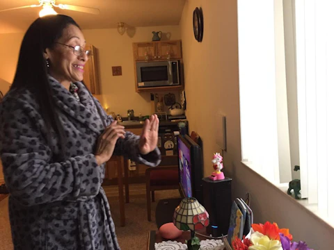 Maria Guzman shows some of the items given to her for use in her apartment, part of the Solis Circle affordable housing project in Altoona that opened in September. (Photo by Julian Emerson)
