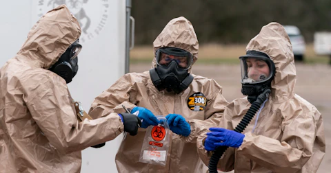 Wisconsin National Guard members Sgt. Nathaniel Nyquist, left, Sgt. John Clark and Spc. Madeline Westrick gather samples at a drive-up COVID-19 testing site near Baraboo on April 29. (Photo © Andy Manis)