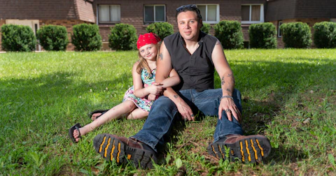 Joshua Crouse and his 10-year-old daughter, Marley, sit outside their Janesville apartment at the end of July. Crouse is among thousands of Wisconsin residents struggling to pay rent each month because of the economy during the pandemic. (Photo © Andy Manis)