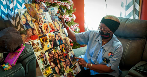 Irene Alexander holds a collage of photos of her great-granddaughter Anisa Scott at her home Tuesday. A community call to action led by the Boys & Girls Club of Dane County is renovating Alexander's home in time for the holidays. (Photo © Andy Manis)