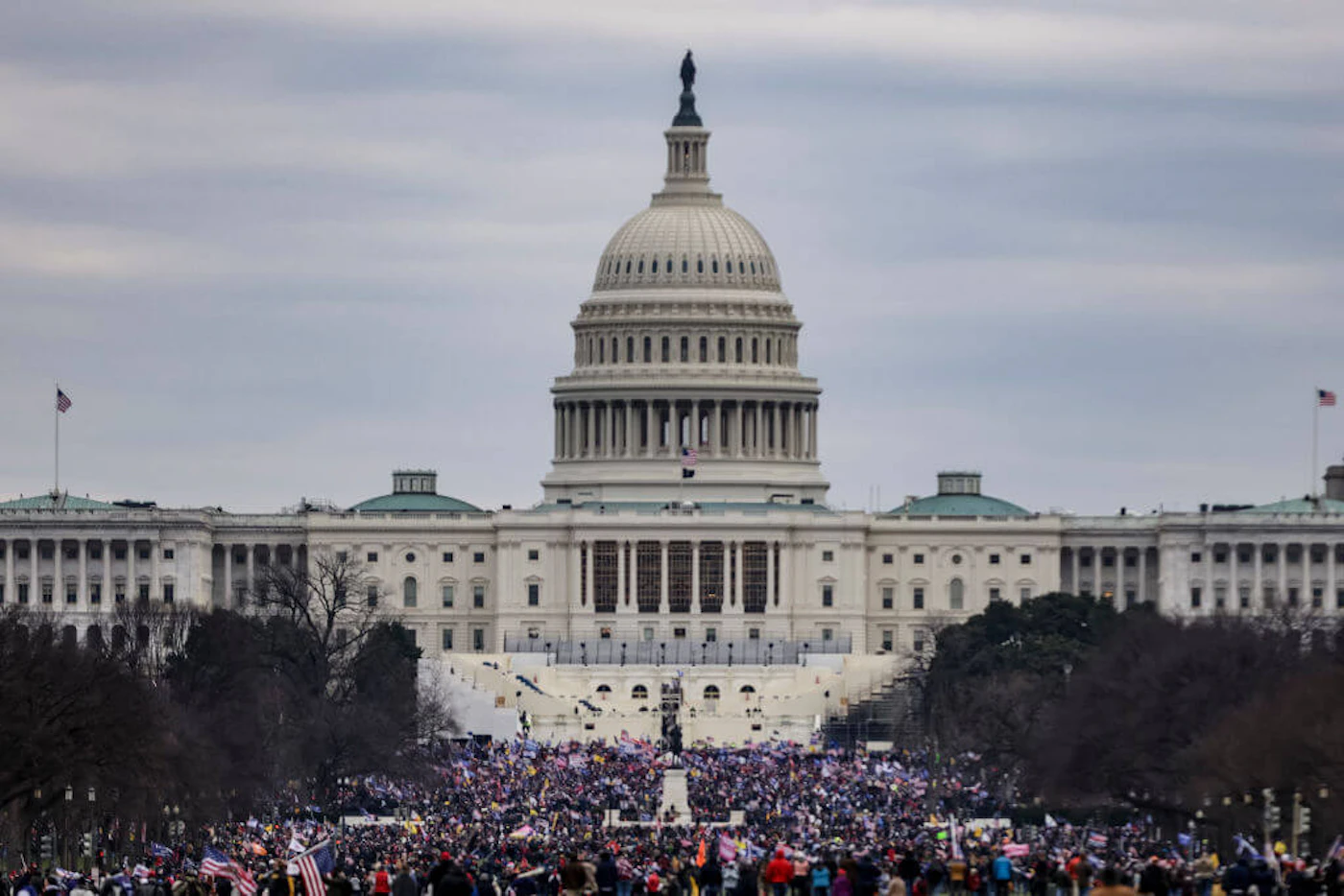 Supporters of President Donald Trump surround the US Capitol following a rally on January 6, 2021 in Washington, DC. Trump supporters stormed the building in an insurrection aimed at stopping Congress from certifying Joe Biden's victory. (Photo by Samuel Corum/Getty Images)
